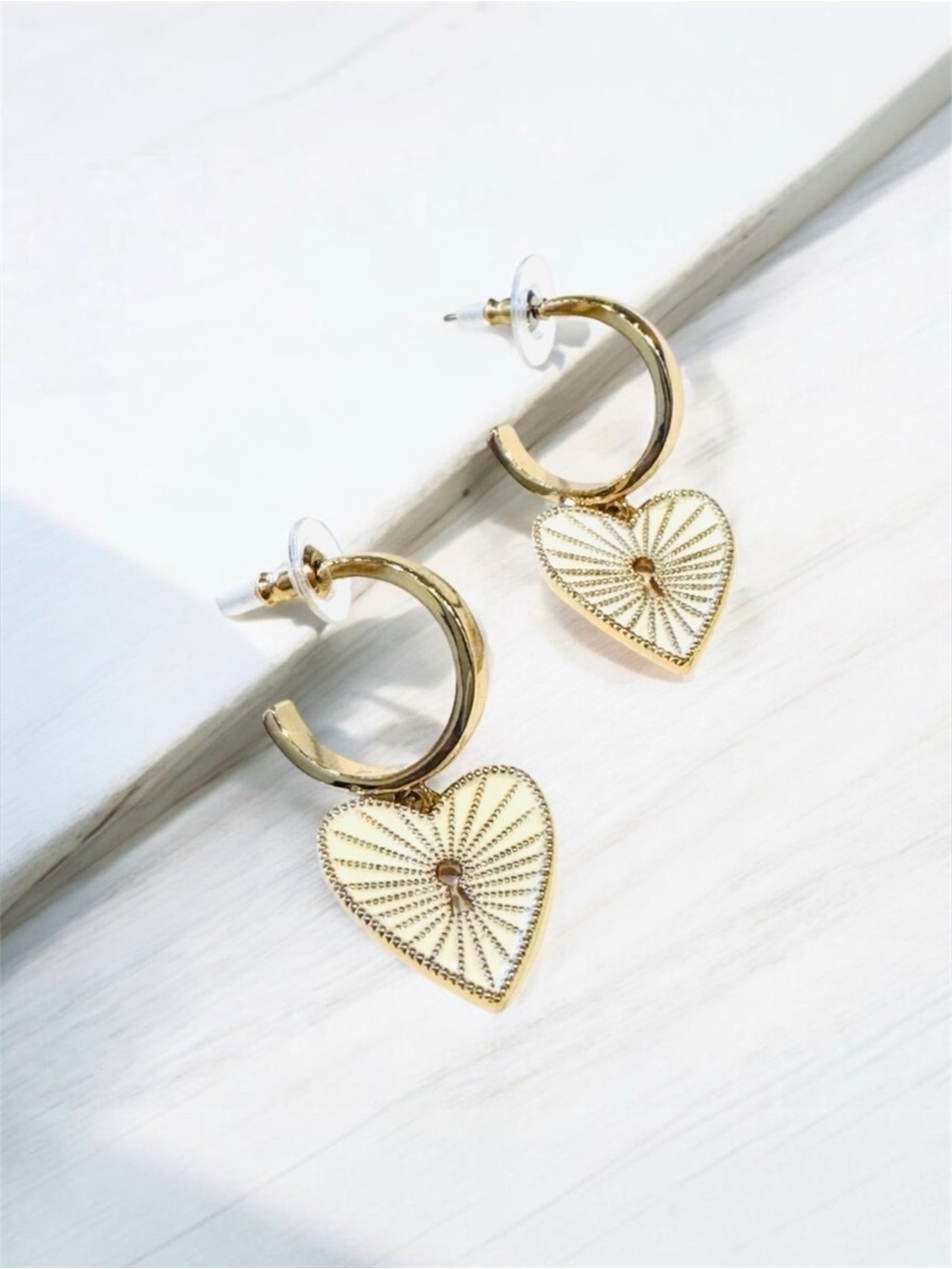 Gold hoop  earrings with heart shaped Charms attached